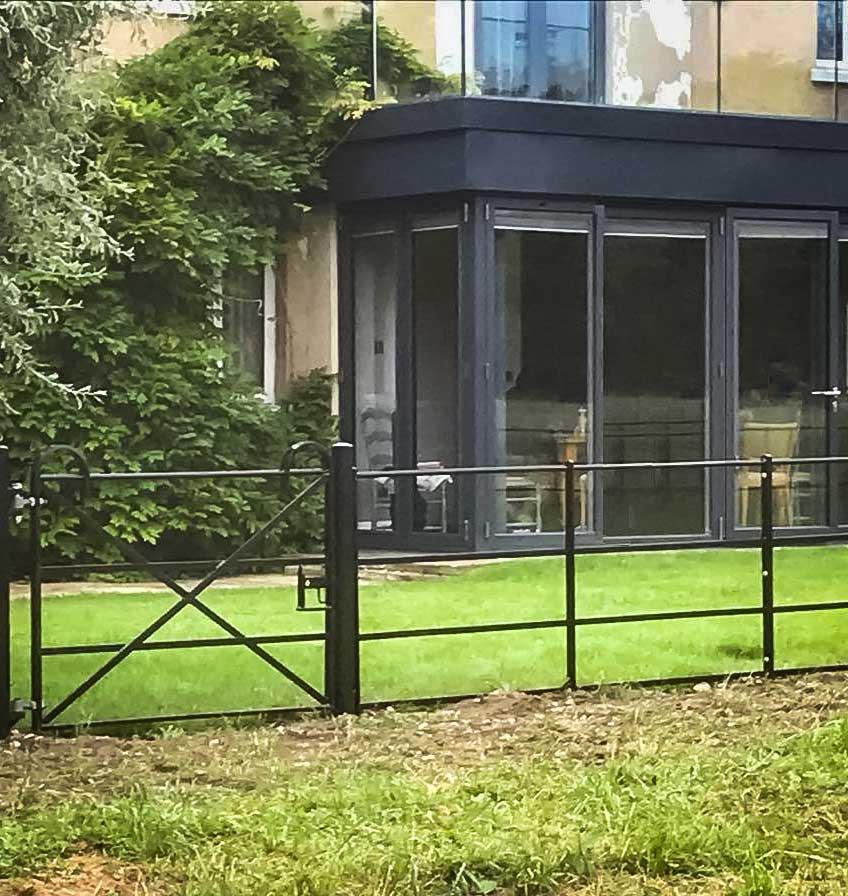 Image of a rustic cleft chestnut fence installed by Farm & Country Fencing, providing an attractive and eco-friendly boundary solution for any property.