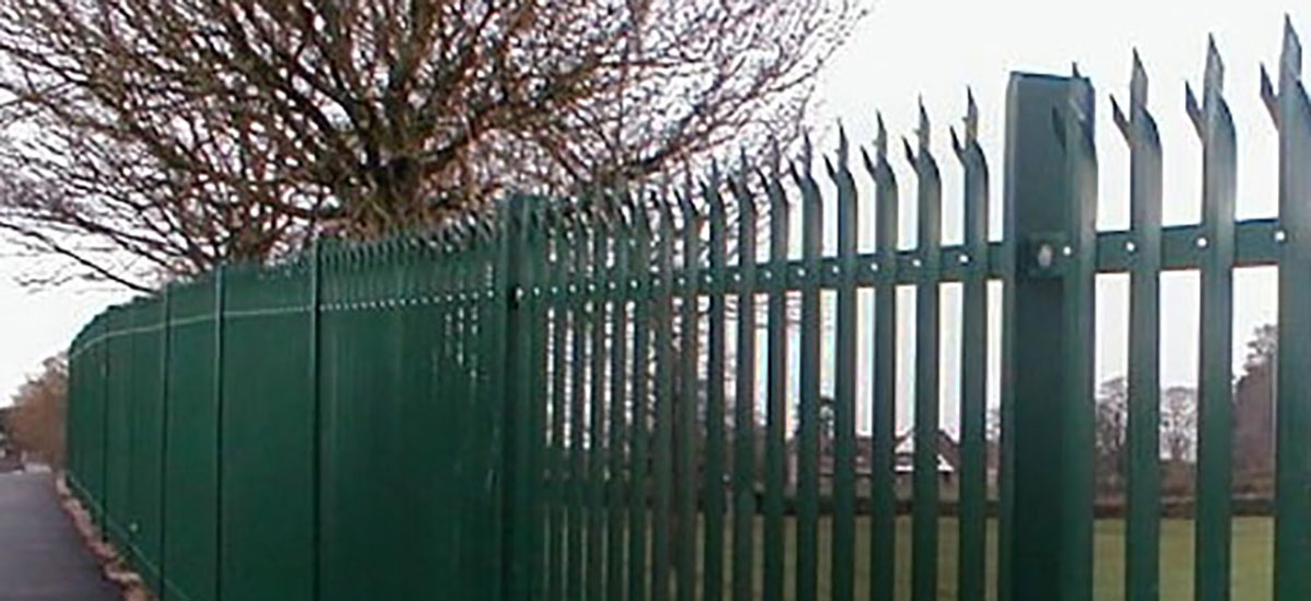 Grazing horses next to a scalloped post and rail fencing put in place by Farm &amp; Country Fencing