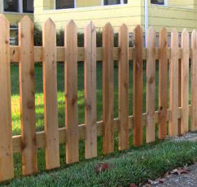 Traditional picket fence, expertly constructed by Farm & Fencing, adding a charming touch to a residential property.
