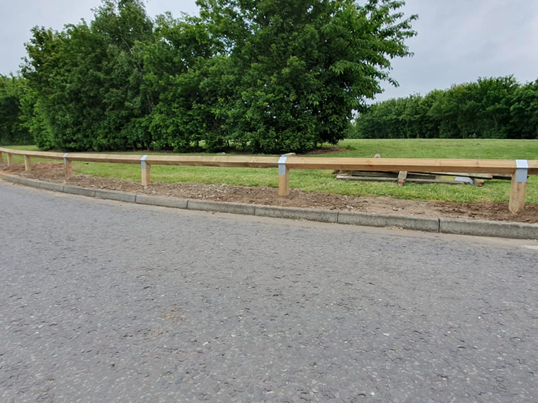 Knee rail fencing protecting grass verge from vehicles