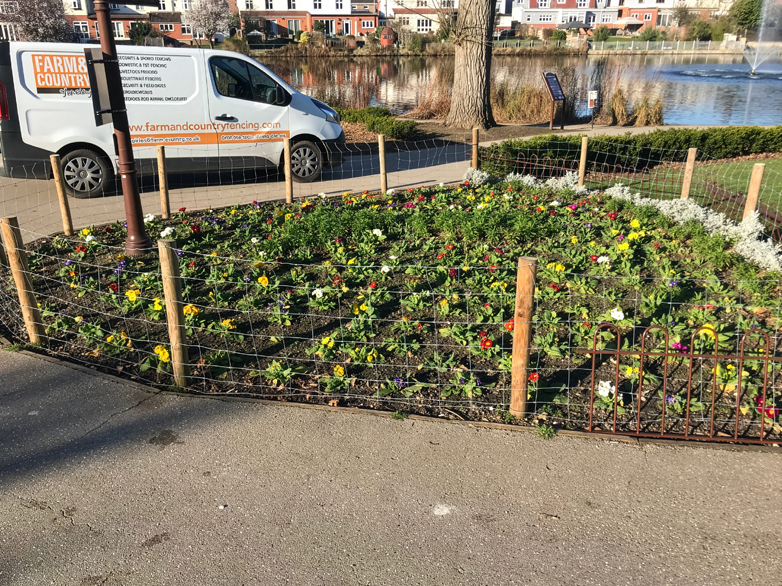 Close-up of Custom Bow Top Fencing Around Garden Bed