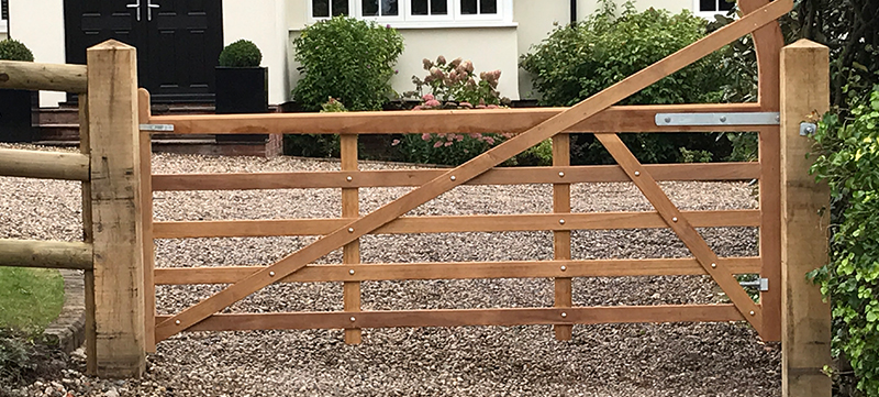 Iroko hardwood entrance gates installed on oak posts