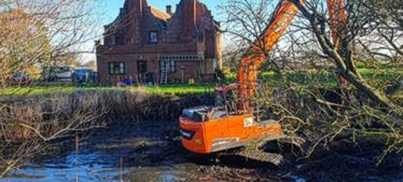 Pond clearing using long reach excavator