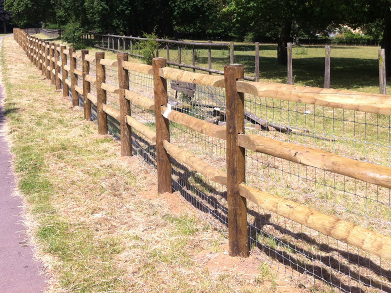 Heavy post and rail morticed fence with concrete foundations