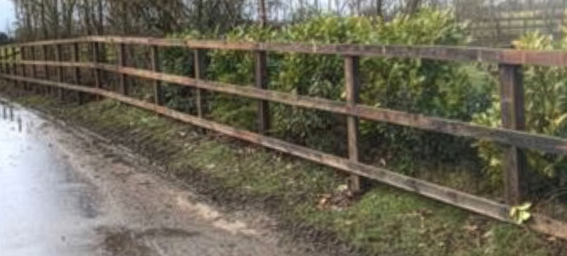 Pressure treated post and rail fence with gate at a country property in Twinstead