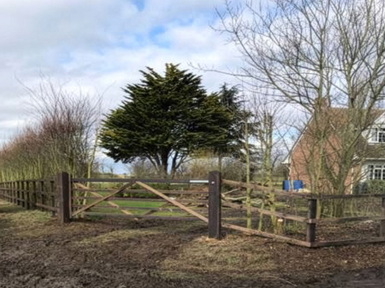 Post and rail fencing with timber gate on rural property