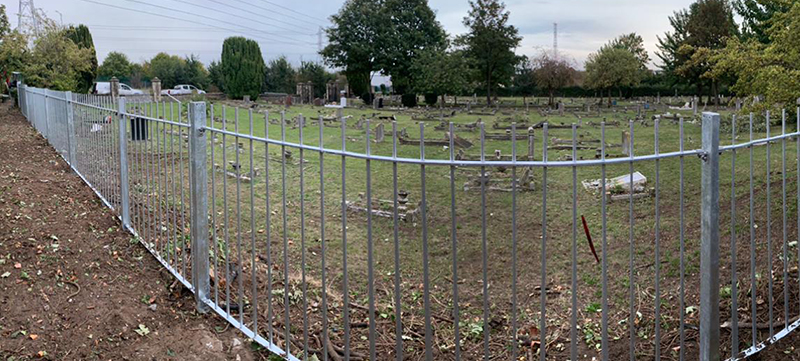 Vertical Metal Railings at Cemetery Edge