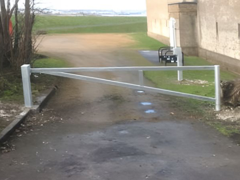 Hingeless barrier installed beside cast iron bollards