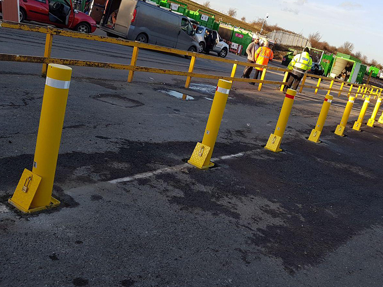 Concrete-finished drop bollards on tarmac