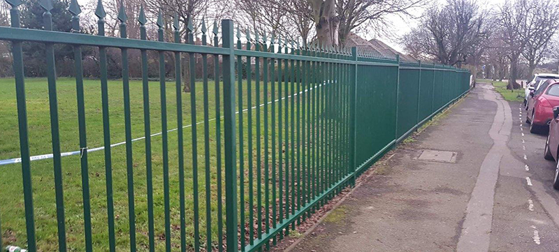 Ornate black railings being repaired and painted