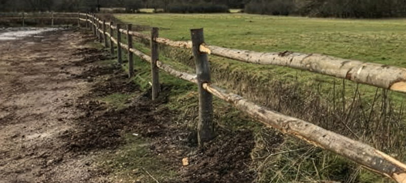 Rustic cleft chestnut post and rail fencing installed in the countryside