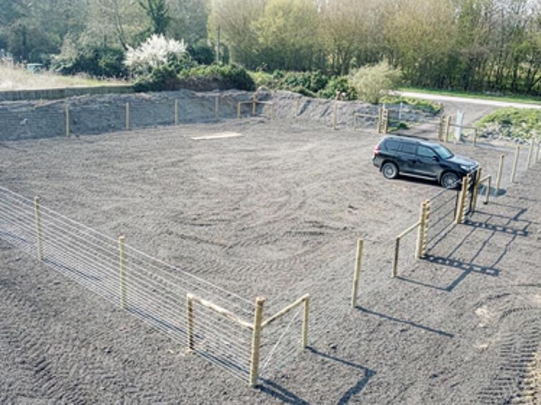 Fenced dog park with open grass and secure access