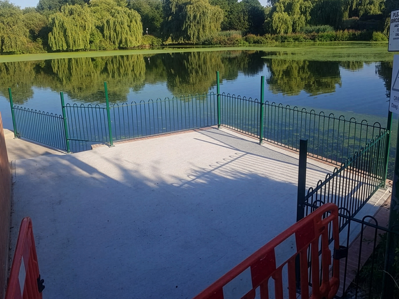Bow top railings along the lake edge at Harrow Lodge Park