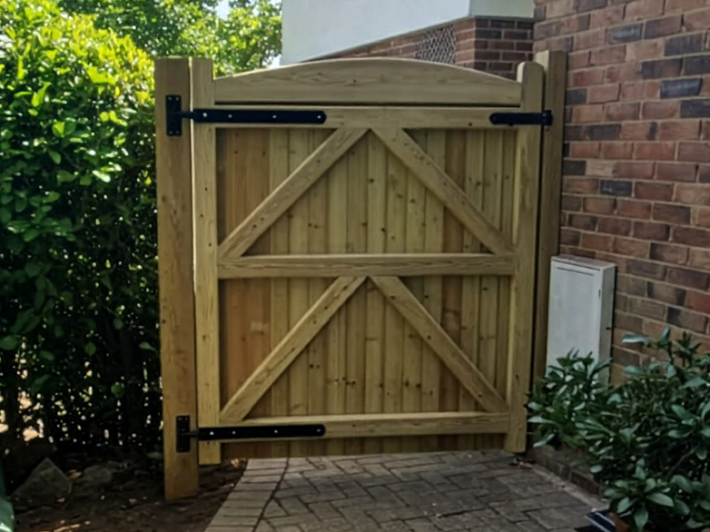 Custom timber sideway gate fitting at property entrance