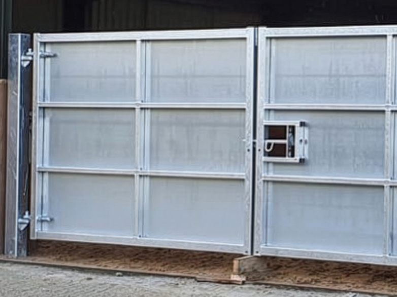 Sheeted steel gates at riding school entrance